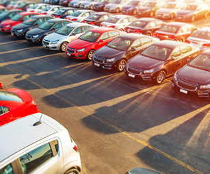 Rows of new cars at a car dealership. A motor trade insurance policy arranged by CSW insurance brokers could cover your garage.