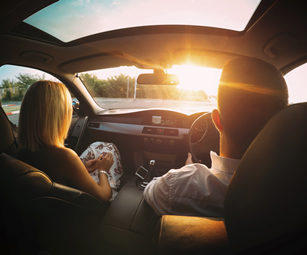 A couple driving, covered by a private car insurance policy arranged by CSW Insurance